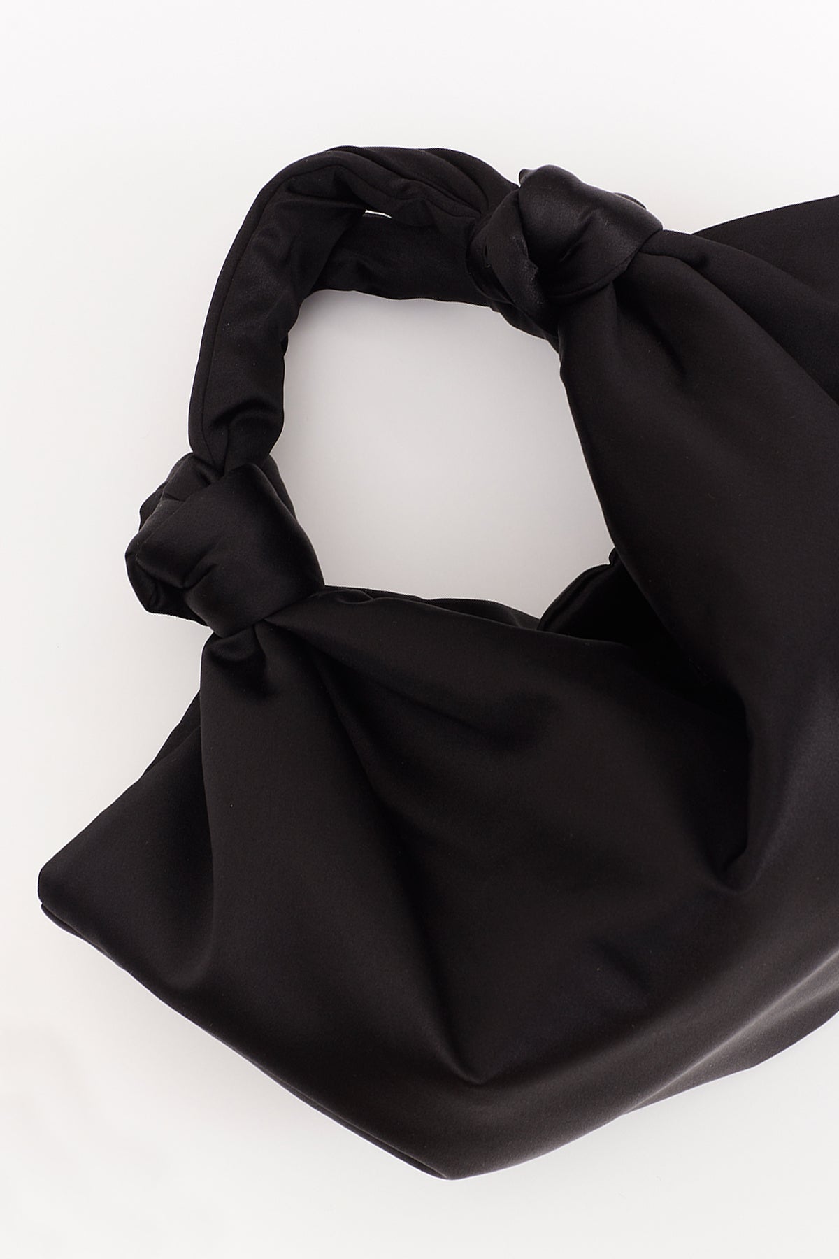   A ROBYN BAG by Velvet by Jenny Graham, a luxury handbag made of black satin with a knot on it. 