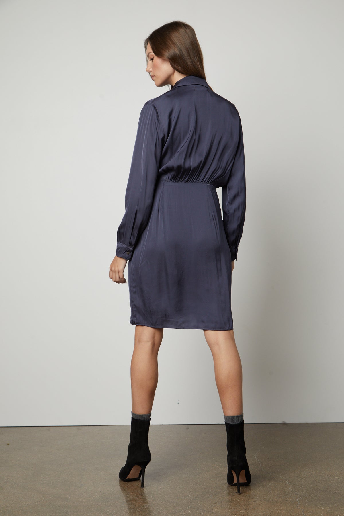 The back view of a woman wearing the Velvet by Graham & Spencer JUNI WRAP DRESS with v-neckline.-35656155300033