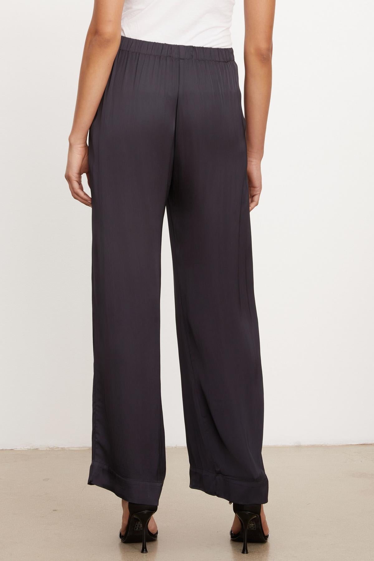   The back view of a woman wearing Velvet by Graham & Spencer's LIVI SATIN VISCOSE WIDE LEG PANT. 