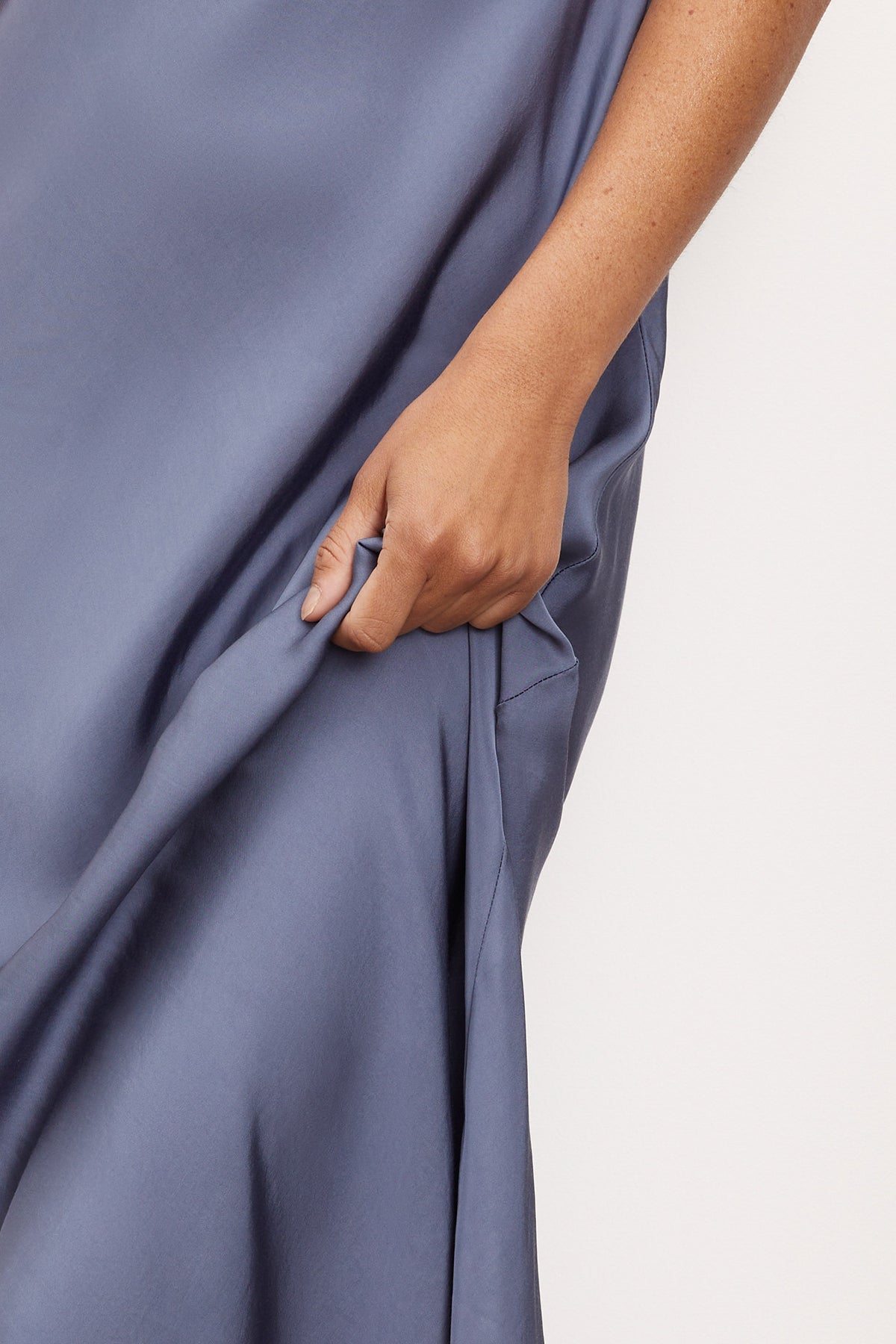 A woman wearing a versatile Velvet by Graham & Spencer POPPY SATIN SLIP DRESS with adjustable straps.-36001442103489