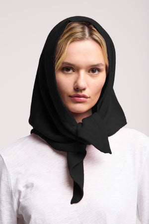 A woman with blonde hair wears the LARGE TRIANGLE BANDANA BY 40 COLORI by 40 Colori, styled under her chin like Italian accessories, and a white shirt, looking at the camera against a plain light background.