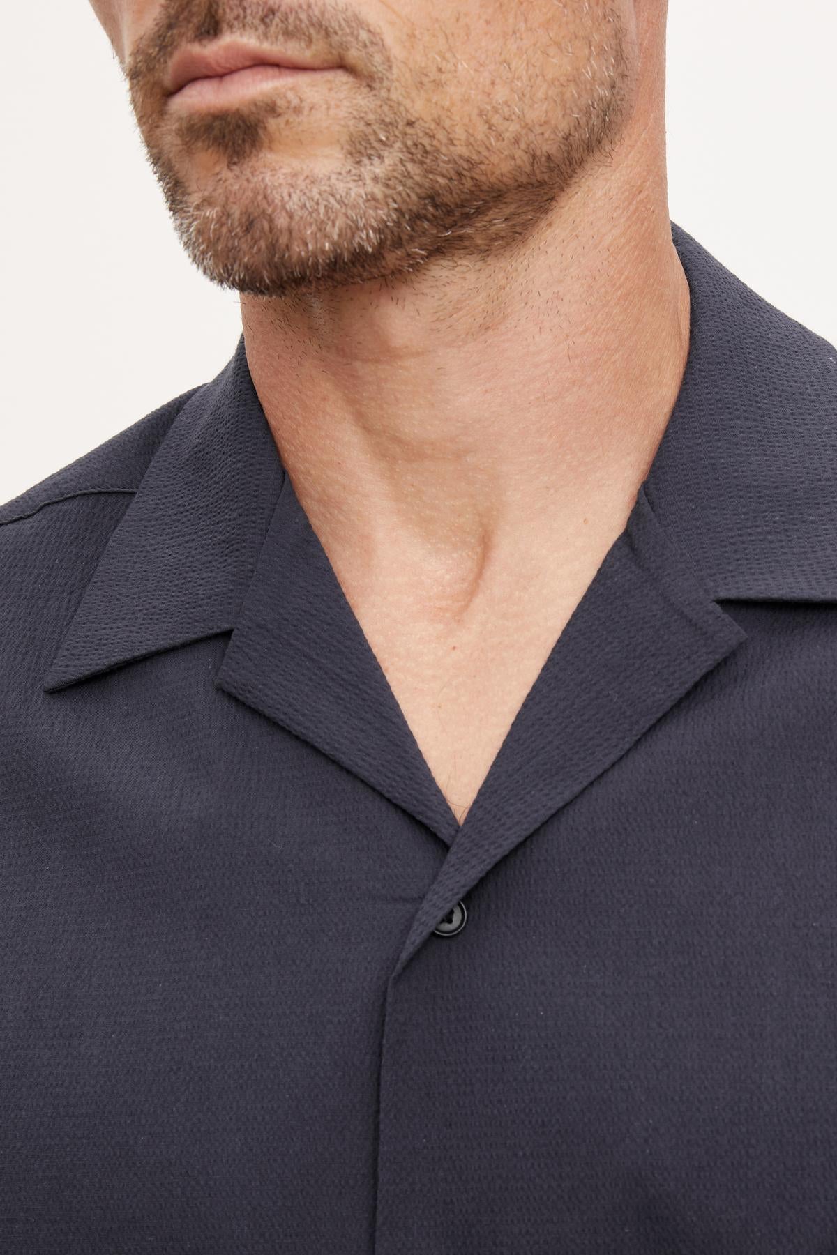 A close up of a man's neck in a Velvet by Graham & Spencer FRANK BUTTON-UP SHIRT.-36890699694273