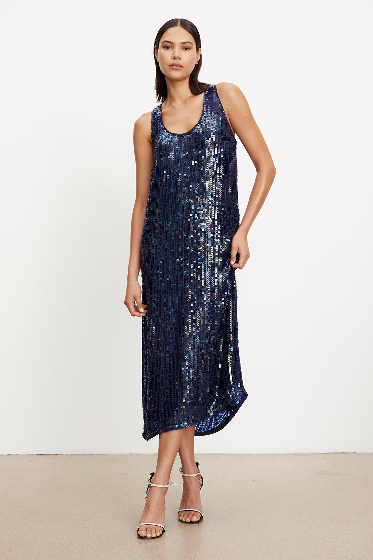   A model wearing an elegant Velvet by Graham & Spencer Alena Sequin Tank Dress. 