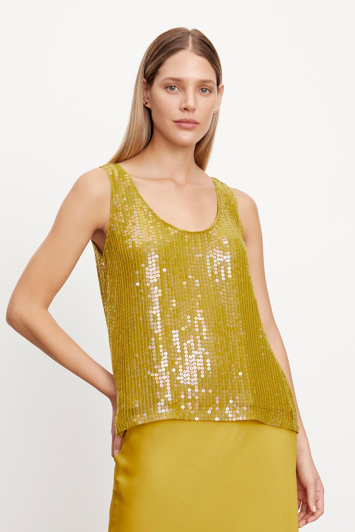   The model is wearing a chic, yellow BEHATI SEQUIN TANK TOP with a-line silhouette from Velvet by Graham & Spencer. 