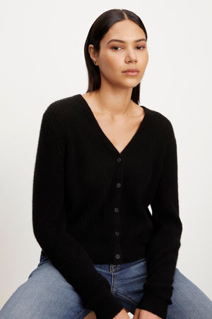 The model is wearing a Coralie Cashmere Cardigan by Velvet by Graham & Spencer.