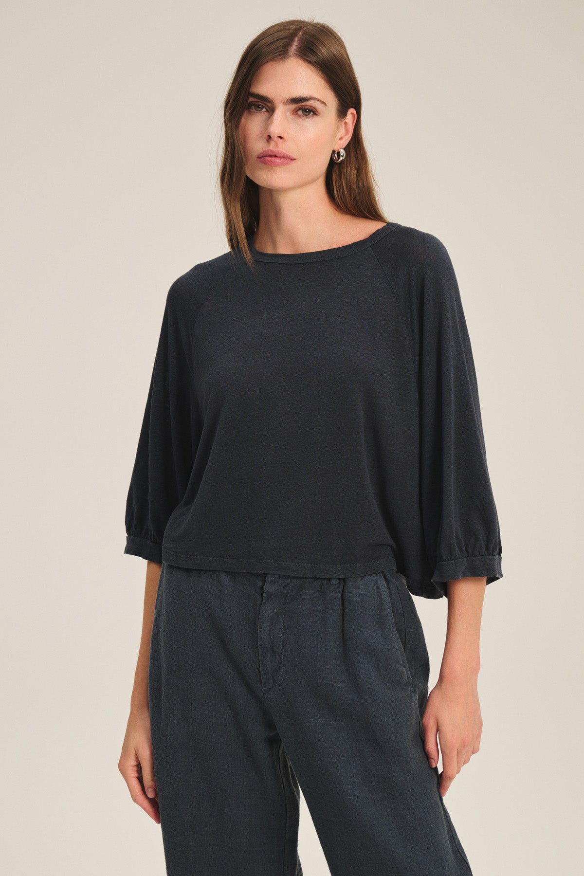 A woman wears the SHELLY TEE by Velvet by Graham & Spencer with matching relaxed pants, standing against a plain light background.