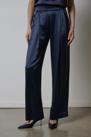 A woman wearing Velvet by Jenny Graham's MANHATTAN PANT and silk charmeuse trousers.