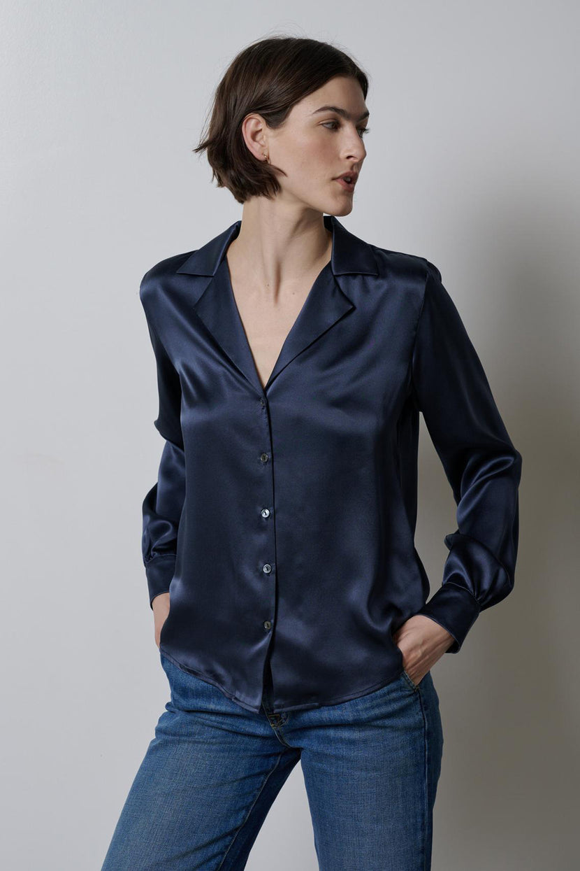 The model is wearing a Velvet by Jenny Graham navy silk charmeuse SOHO TOP, a timeless and elegant choice.
