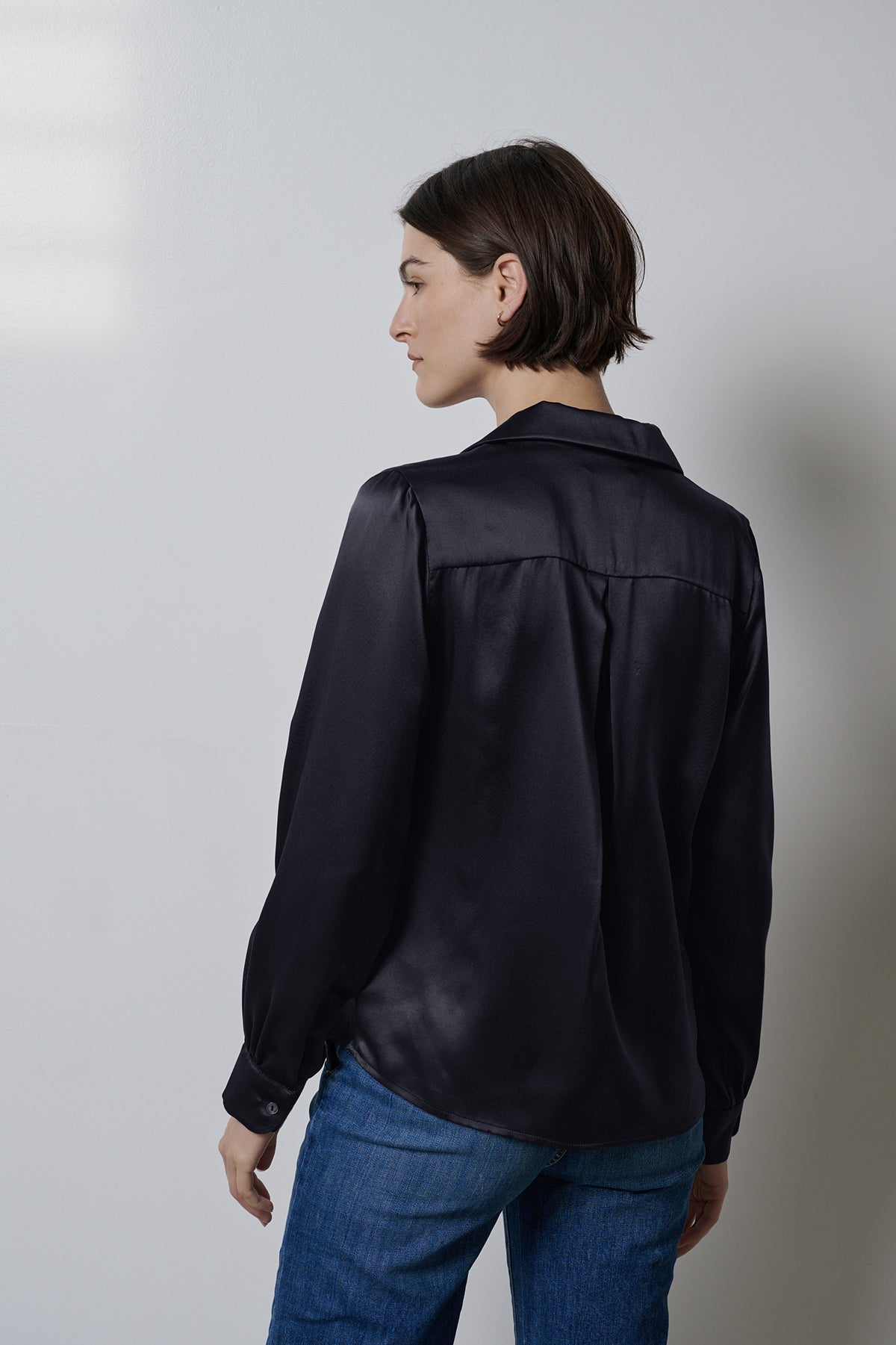   The back view of a timeless woman wearing a Velvet by Jenny Graham SOHO TOP blouse. 