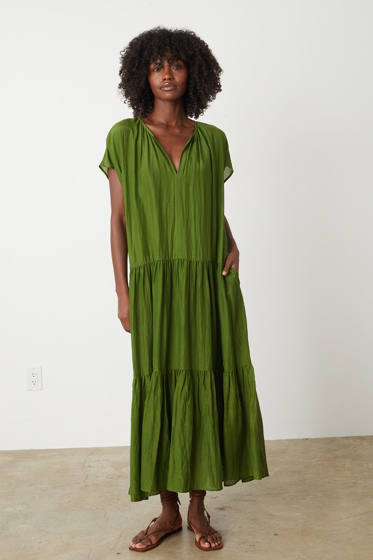 a woman wearing a green ADA TIERED MAXI DRESS by Velvet by Graham & Spencer.-26342688686273