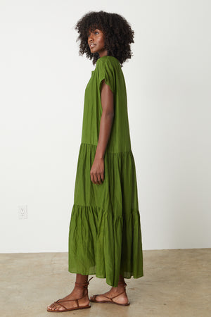 The model is wearing a ADA TIERED MAXI DRESS dress with ruffled ruffles by Velvet by Graham & Spencer.