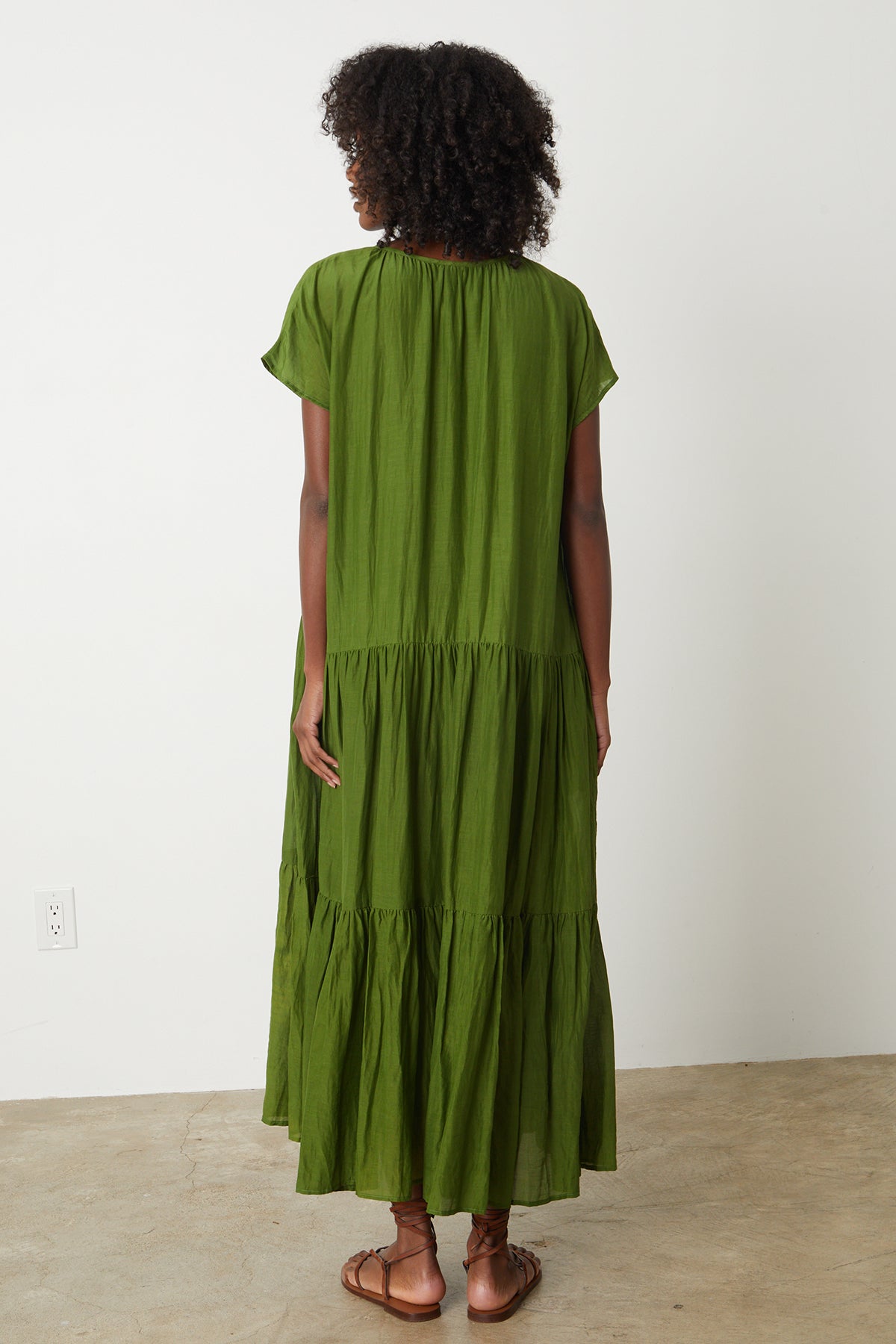   the back view of a woman wearing the Velvet by Graham & Spencer ADA TIERED MAXI DRESS. 