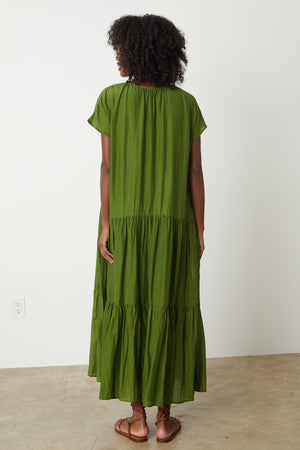 the back view of a woman wearing the Velvet by Graham & Spencer ADA TIERED MAXI DRESS.