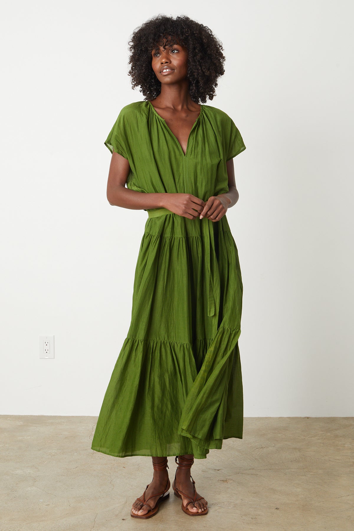   The model is wearing a Velvet by Graham & Spencer ADA TIERED MAXI DRESS with a ruffled hem. 