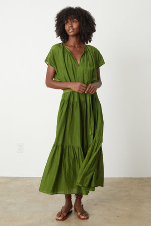 The model is wearing a Velvet by Graham & Spencer ADA TIERED MAXI DRESS with a ruffled hem.