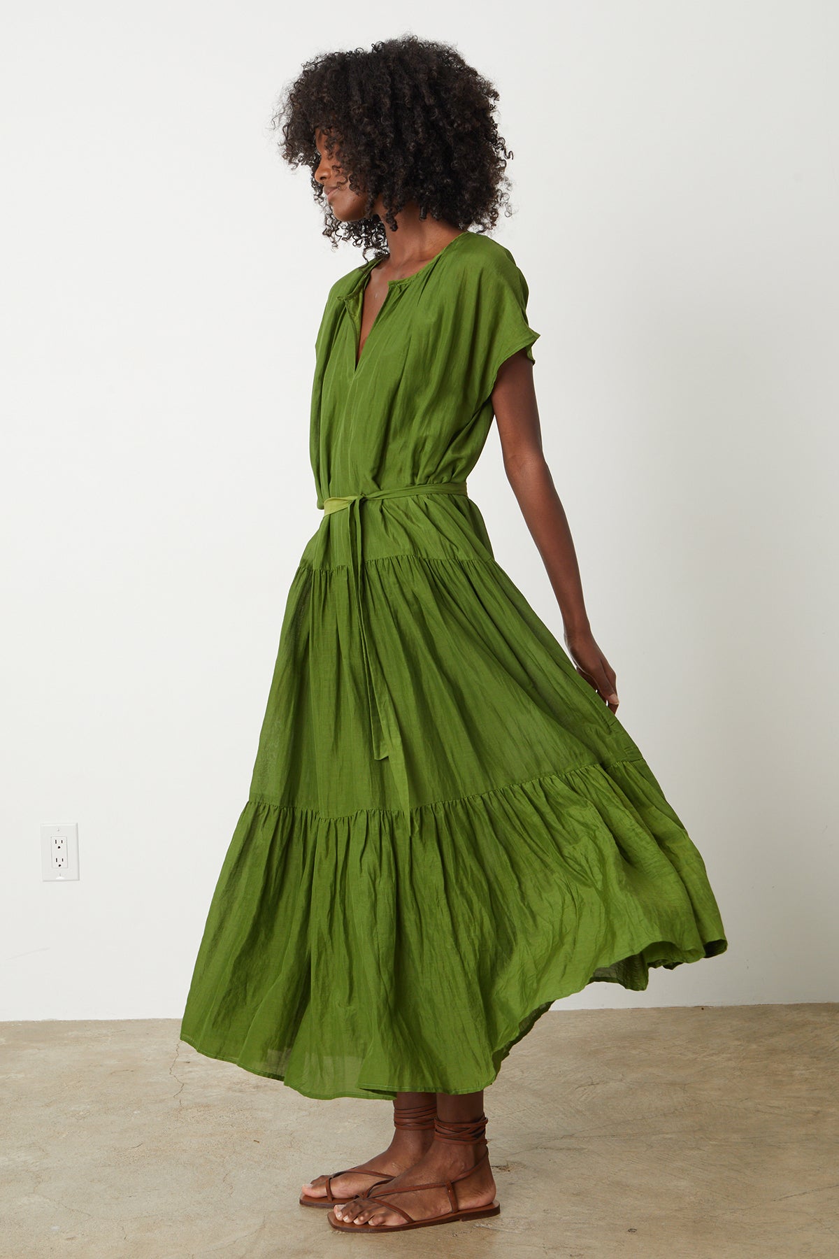 The model is wearing an ADA TIERED MAXI DRESS by Velvet by Graham & Spencer with ruffles.-26342688850113