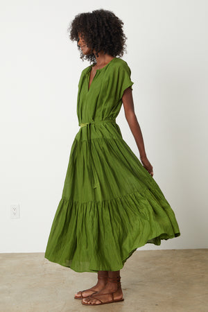 The model is wearing an ADA TIERED MAXI DRESS by Velvet by Graham & Spencer with ruffles.