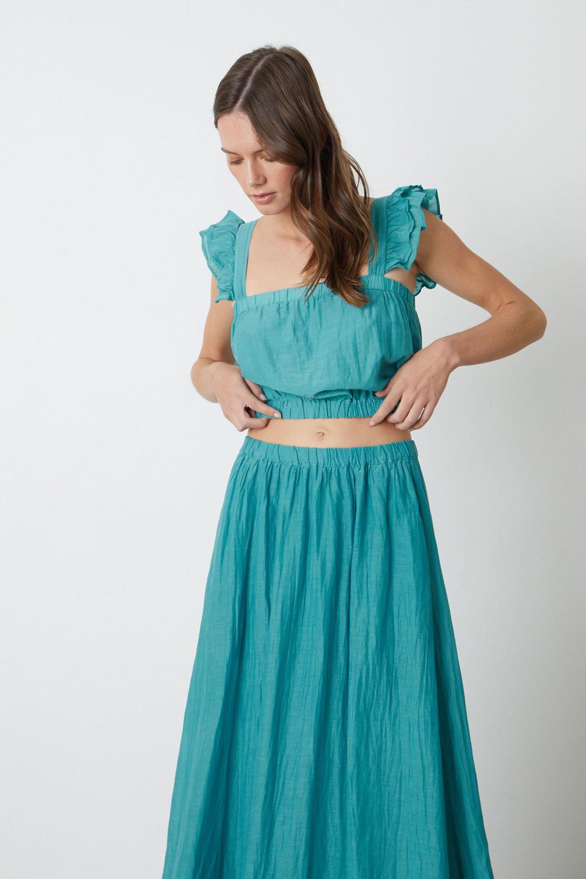 A woman wearing a Velvet by Graham & Spencer teal maxi dress.-26544387260609