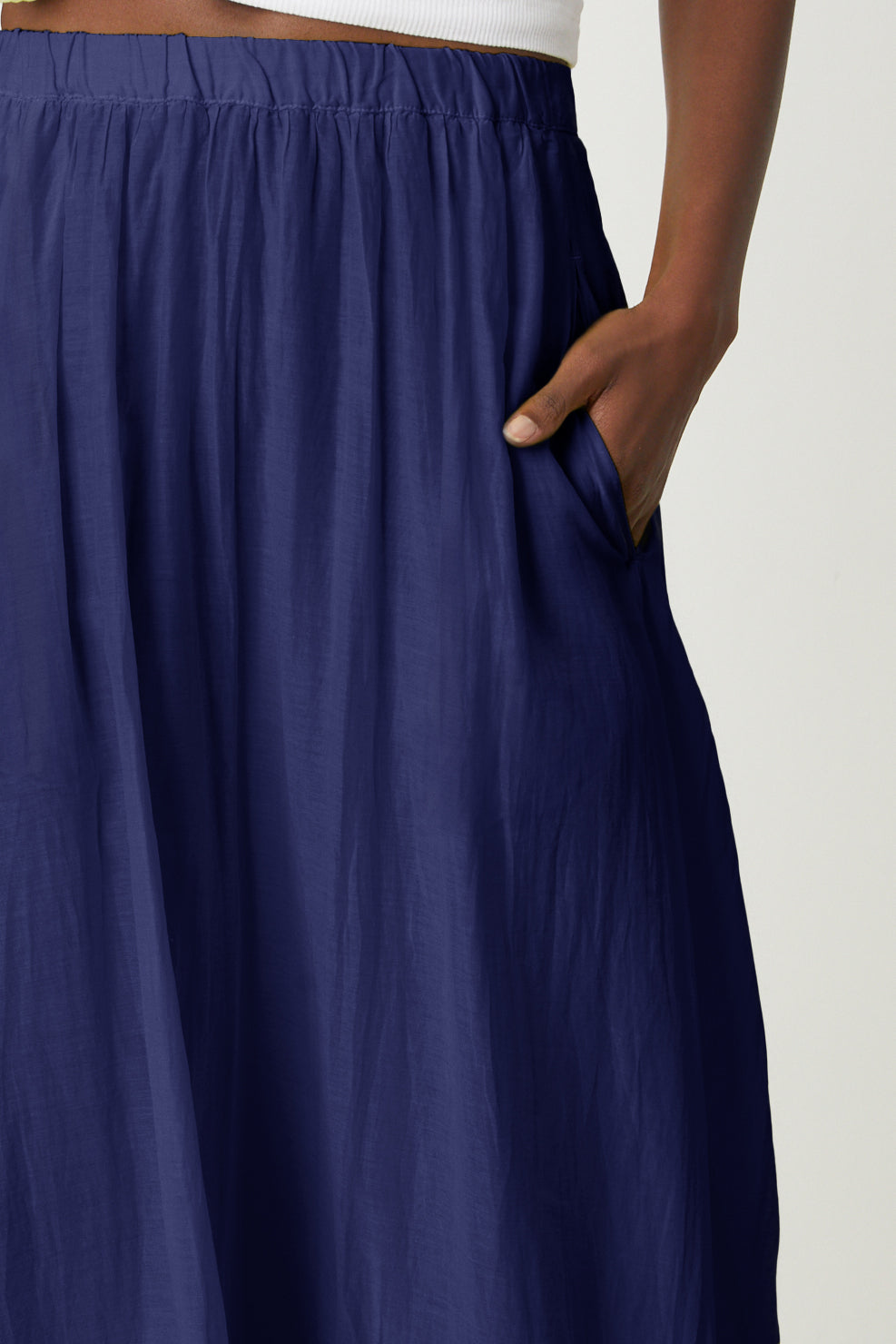   A woman wearing a blue Mariela Maxi Skirt with pocket close up 