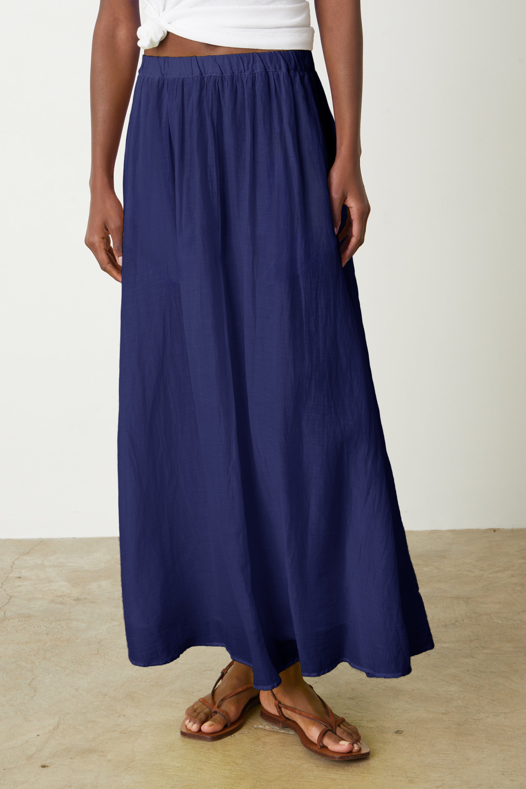   A woman wearing a Velvet by Graham & Spencer Mariela Maxi Skirt. 