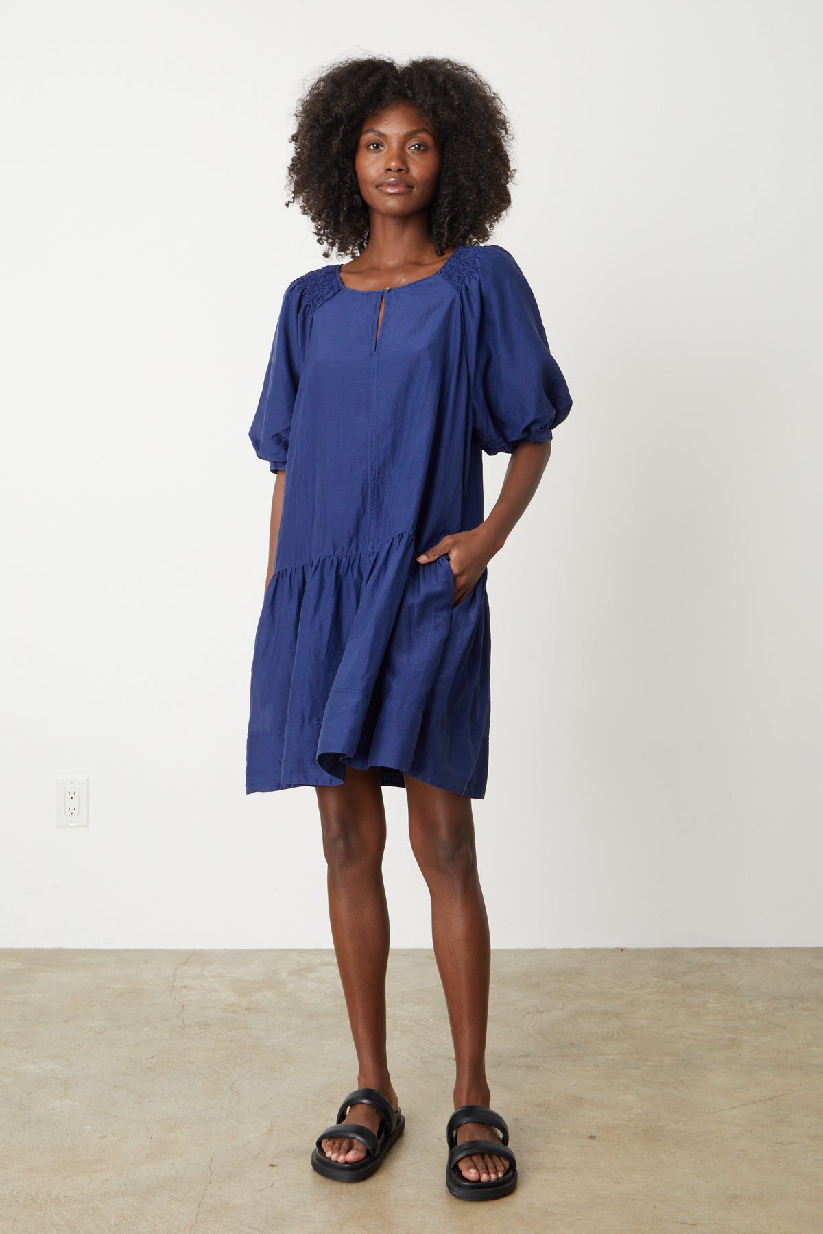   The model is wearing a Velvet by Graham & Spencer REECE SILK COTTON DRESS with a ruffled sleeve. 