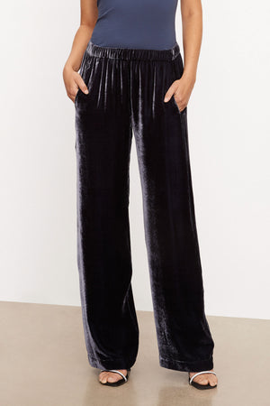 The model is wearing FRIDA SILK VELVET WIDE LEG PANT by Velvet by Graham & Spencer with an elastic waistband.