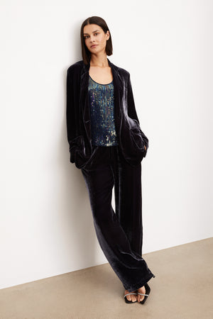A woman wearing a FRIDA SILK VELVET WIDE LEG PANT by Velvet by Graham & Spencer jacket and trousers with an elastic waistband.