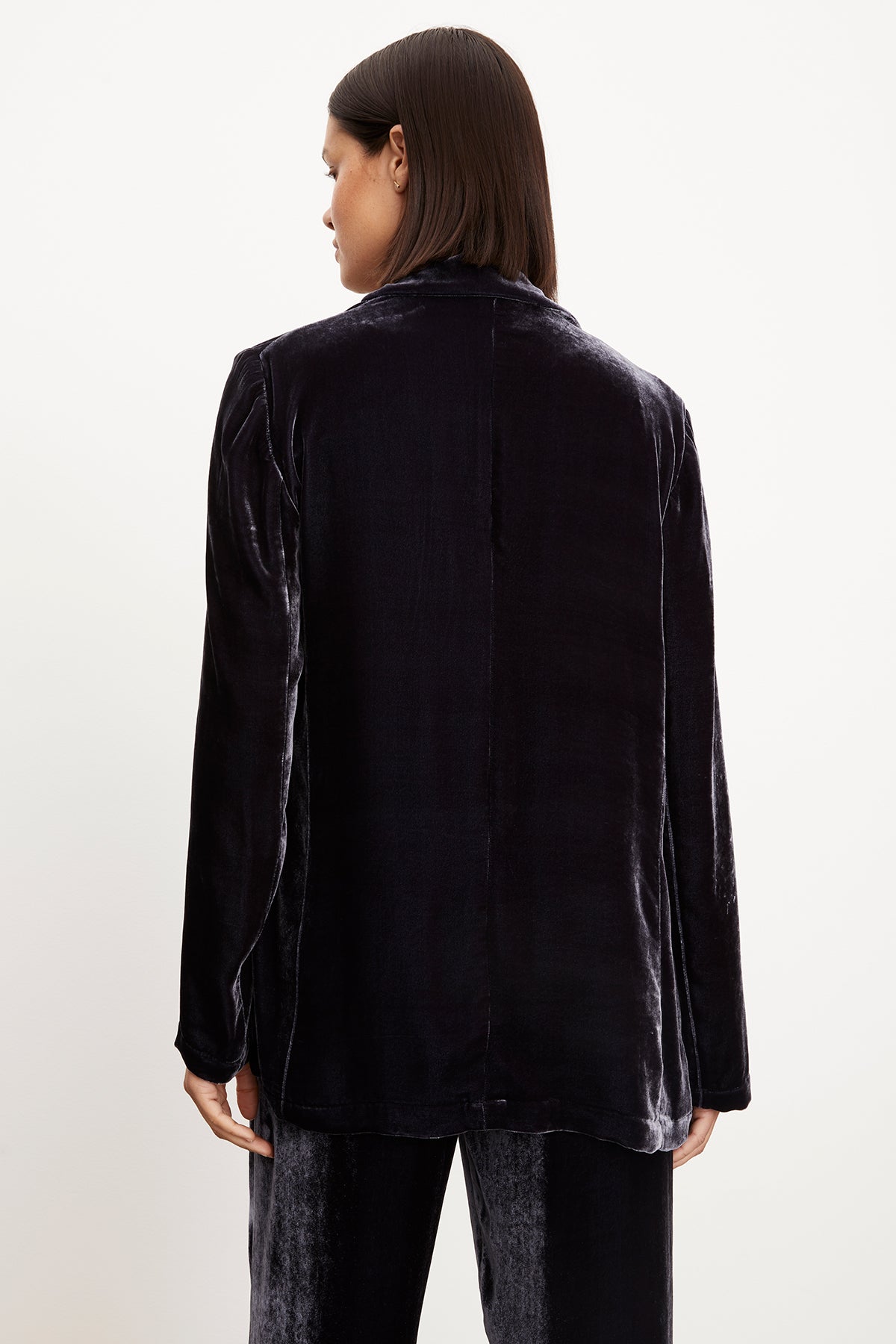 The back view of a person wearing an oversized fit KYLA SILK VELVET BLAZER by Velvet by Graham & Spencer.-35577747996865