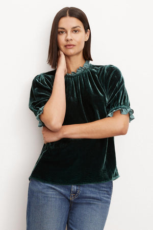 The model is wearing an elegant and timeless VAL SILK VELVET TOP with ruffles by Velvet by Graham & Spencer.