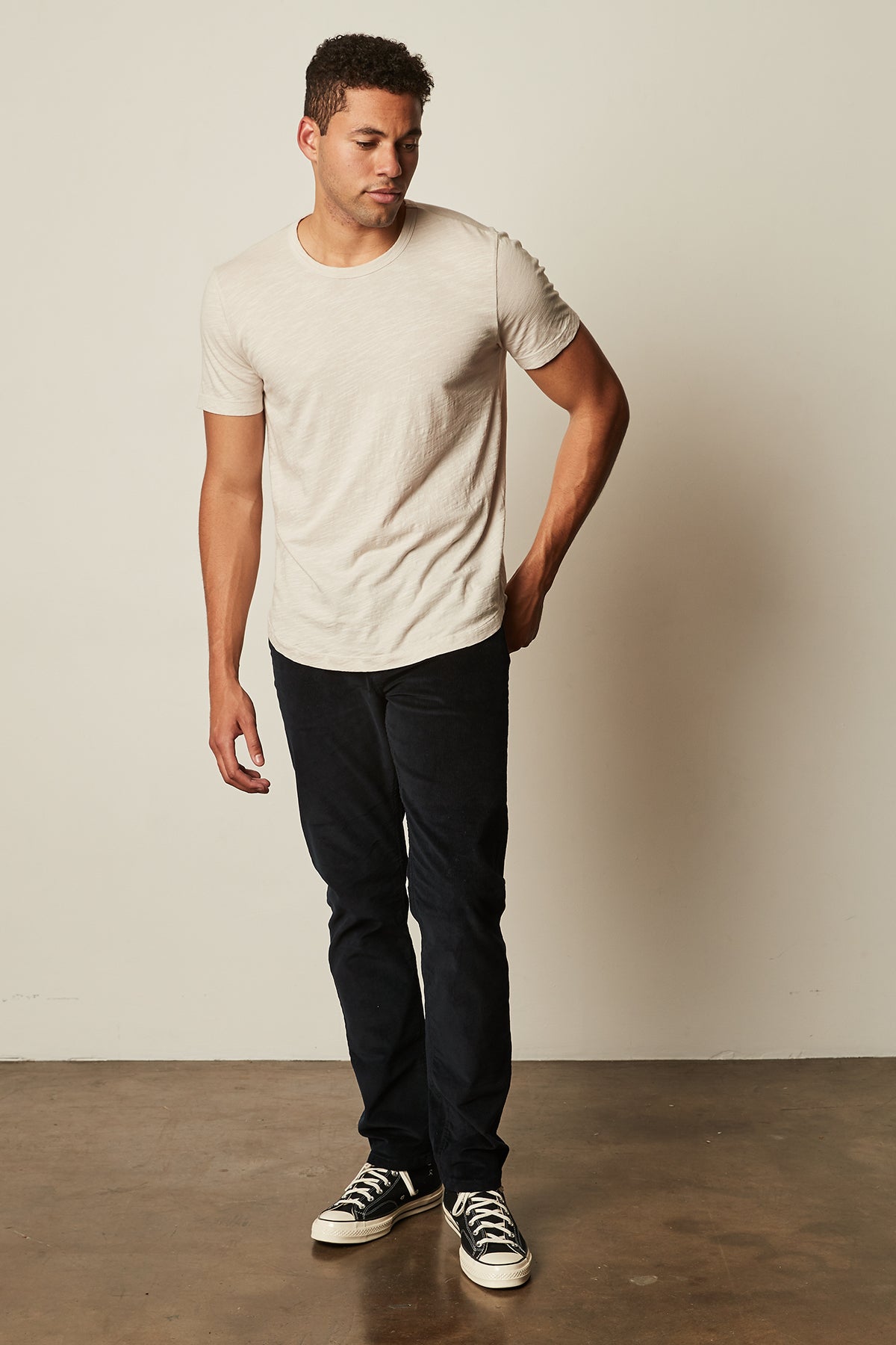   a man wearing a Velvet by Graham & Spencer AMARO CREW NECK SLUB TEE and jeans. 