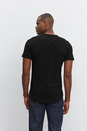 Man wearing a plain black, slub knit Velvet by Graham & Spencer AMARO TEE with a crew neck, viewed from the back.