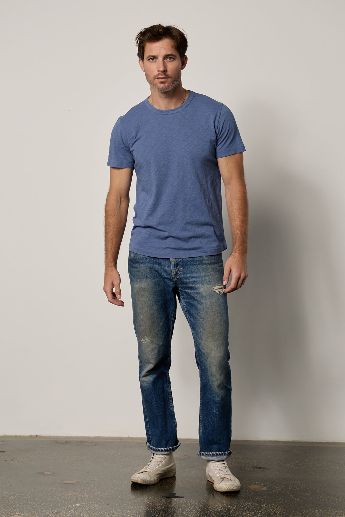   a man wearing jeans and a Velvet by Graham & Spencer AMARO CREW NECK SLUB TEE. 