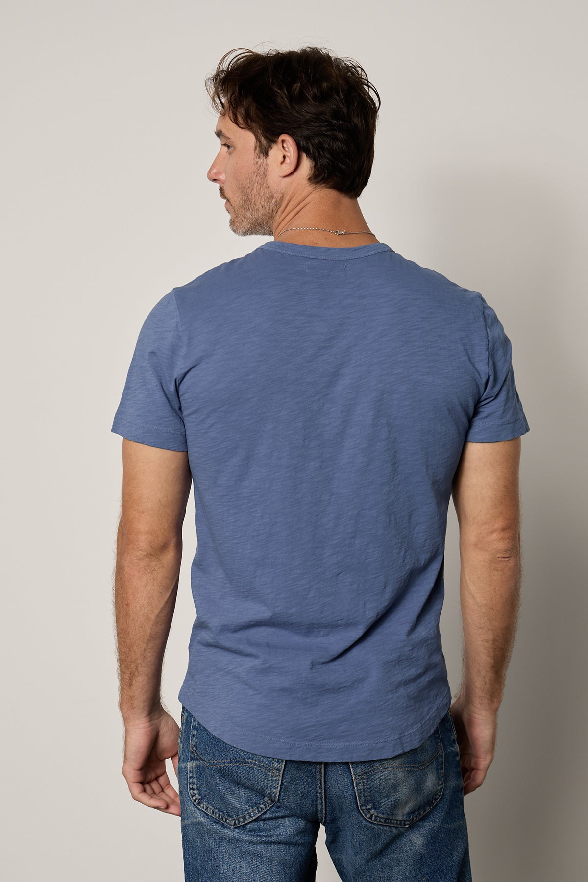   The back view of a man wearing a Velvet by Graham & Spencer AMARO CREW NECK SLUB TEE. 