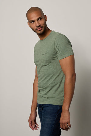 a man wearing jeans and a Velvet by Graham & Spencer CHAD RAW EDGE COTTON SLUB POCKET TEE.
