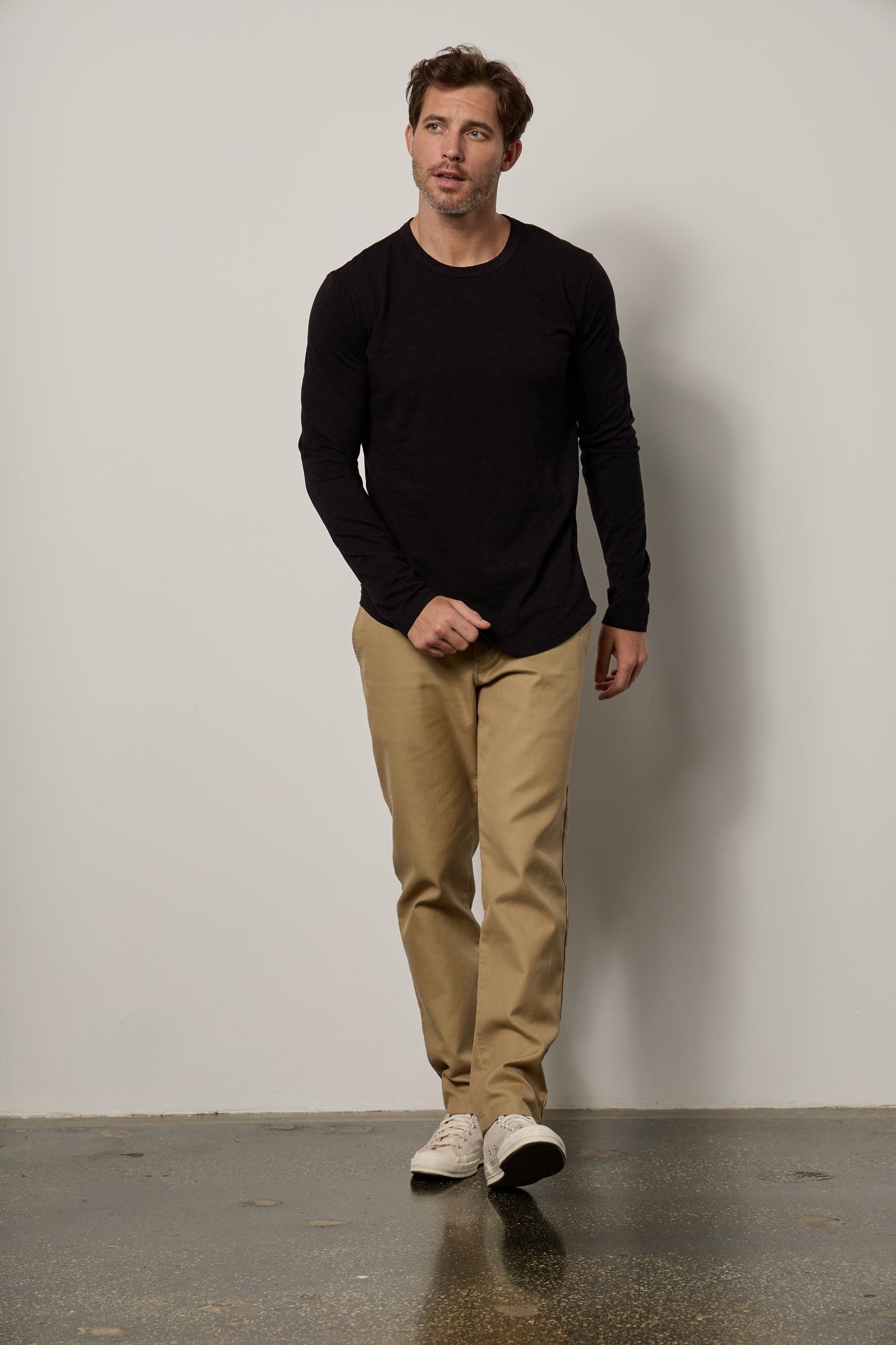 A man in a flawless fit, wearing a Velvet by Graham & Spencer KAI CREW NECK TEE and khaki pants.-35607579099329
