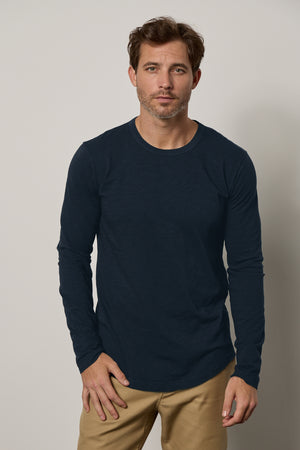 A man wearing a flawless fit Velvet by Graham & Spencer KAI CREW NECK TEE navy long sleeve t-shirt.