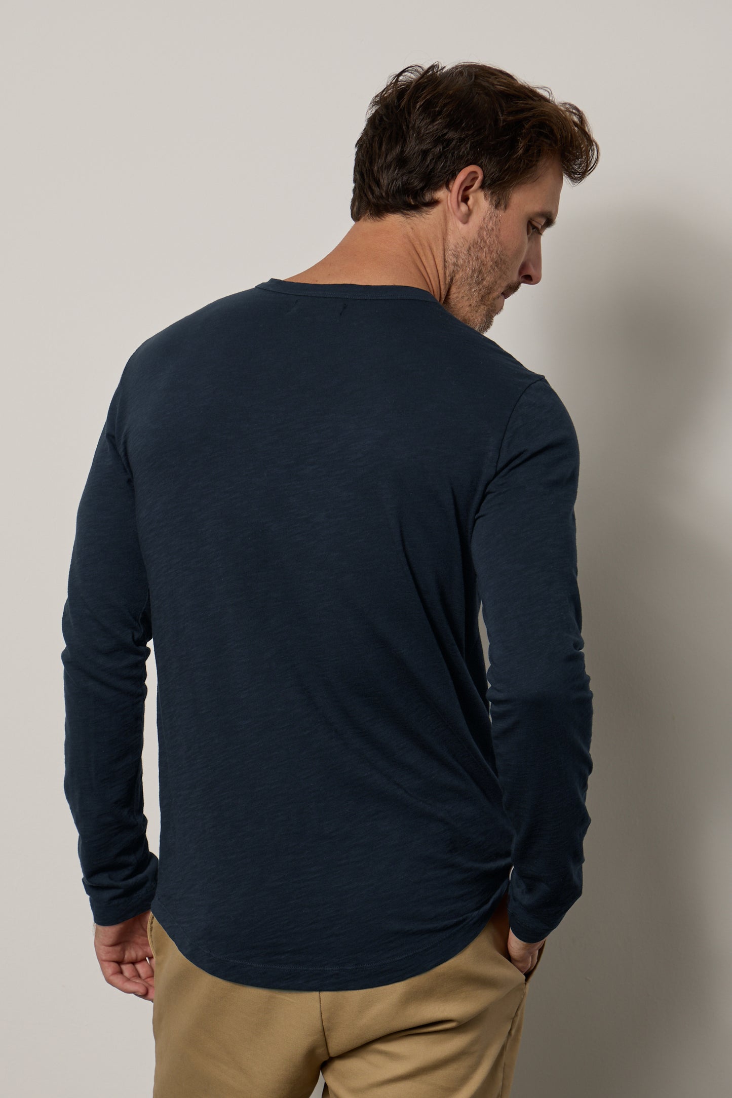 The back view of a man wearing a Velvet by Graham & Spencer KAI CREW NECK TEE showcases the subtle curve and flawless fit of the true slub knit fabric.-35607579263169