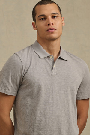 Wearing the Velvet by Graham & Spencer MORRIS POLO in light gray, a person stands against a neutral background, facing the camera.