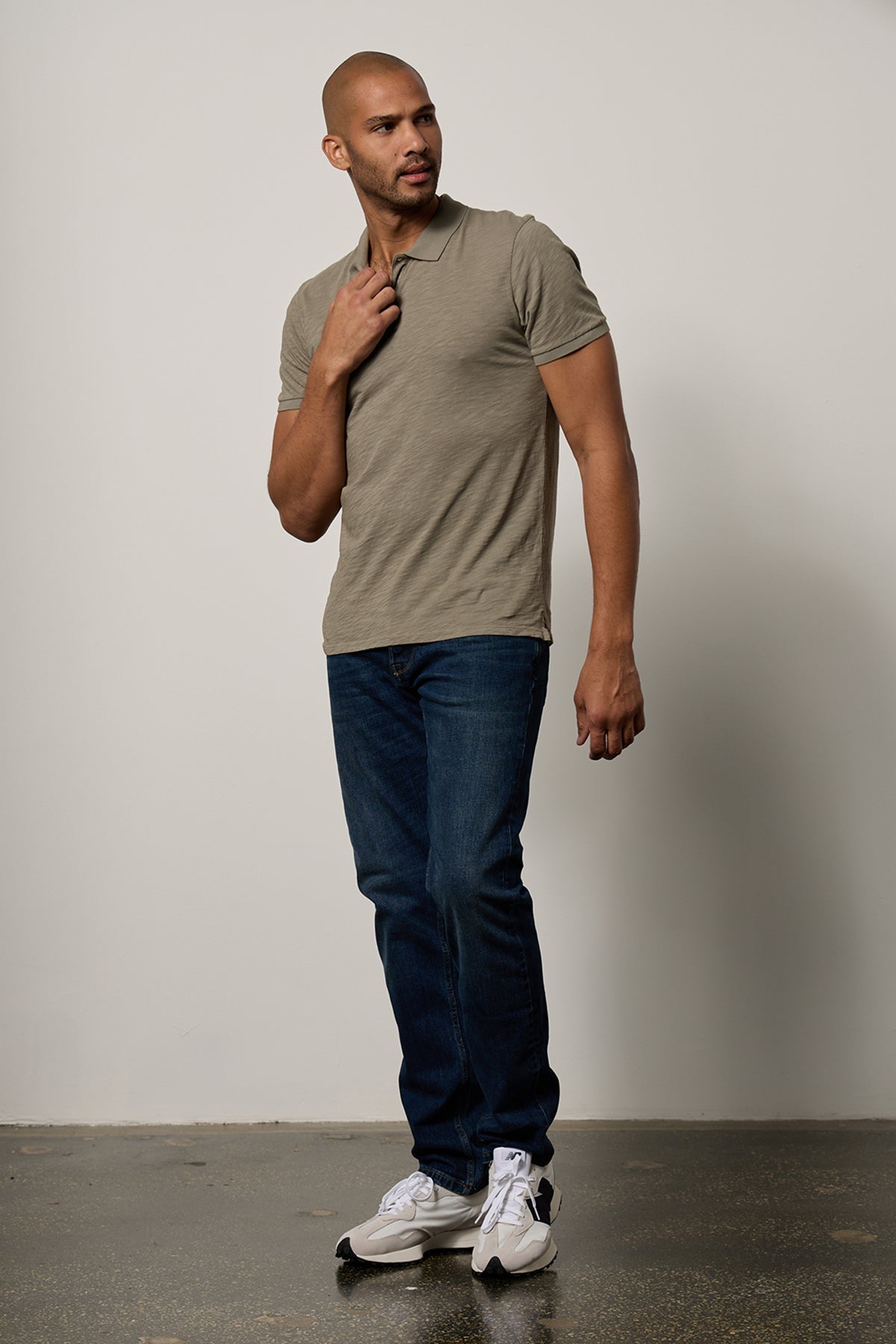 Niko Polo in cypress green with dark blue denim full length front with sneakers in studio-26631352713409