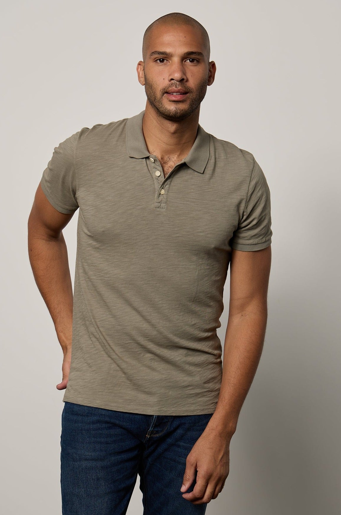   Niko Polo in cypress green with dark blue denim front 