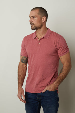 A man wearing a NIKO POLO by Velvet by Graham & Spencer shirt and jeans.