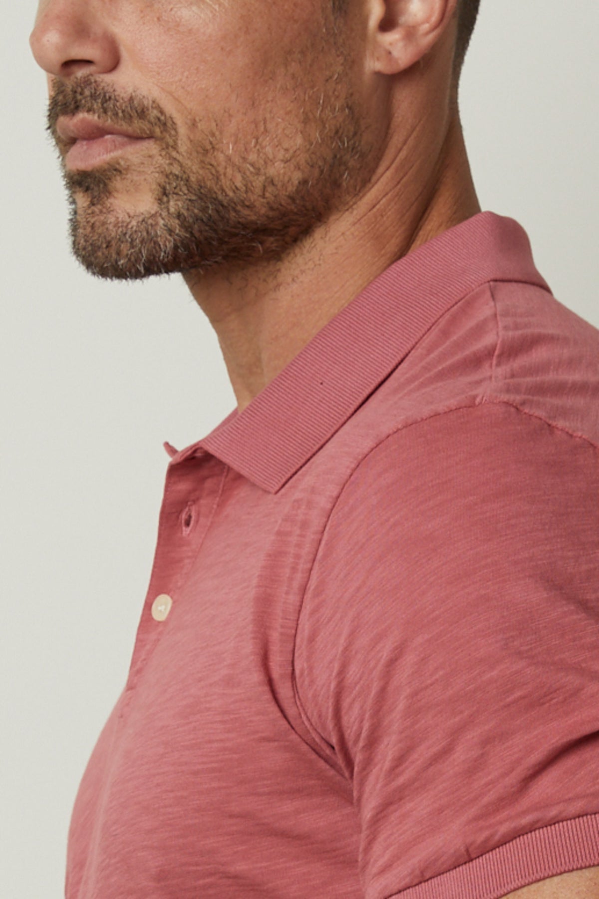   A man wearing a NIKO POLO shirt by Velvet by Graham & Spencer. 