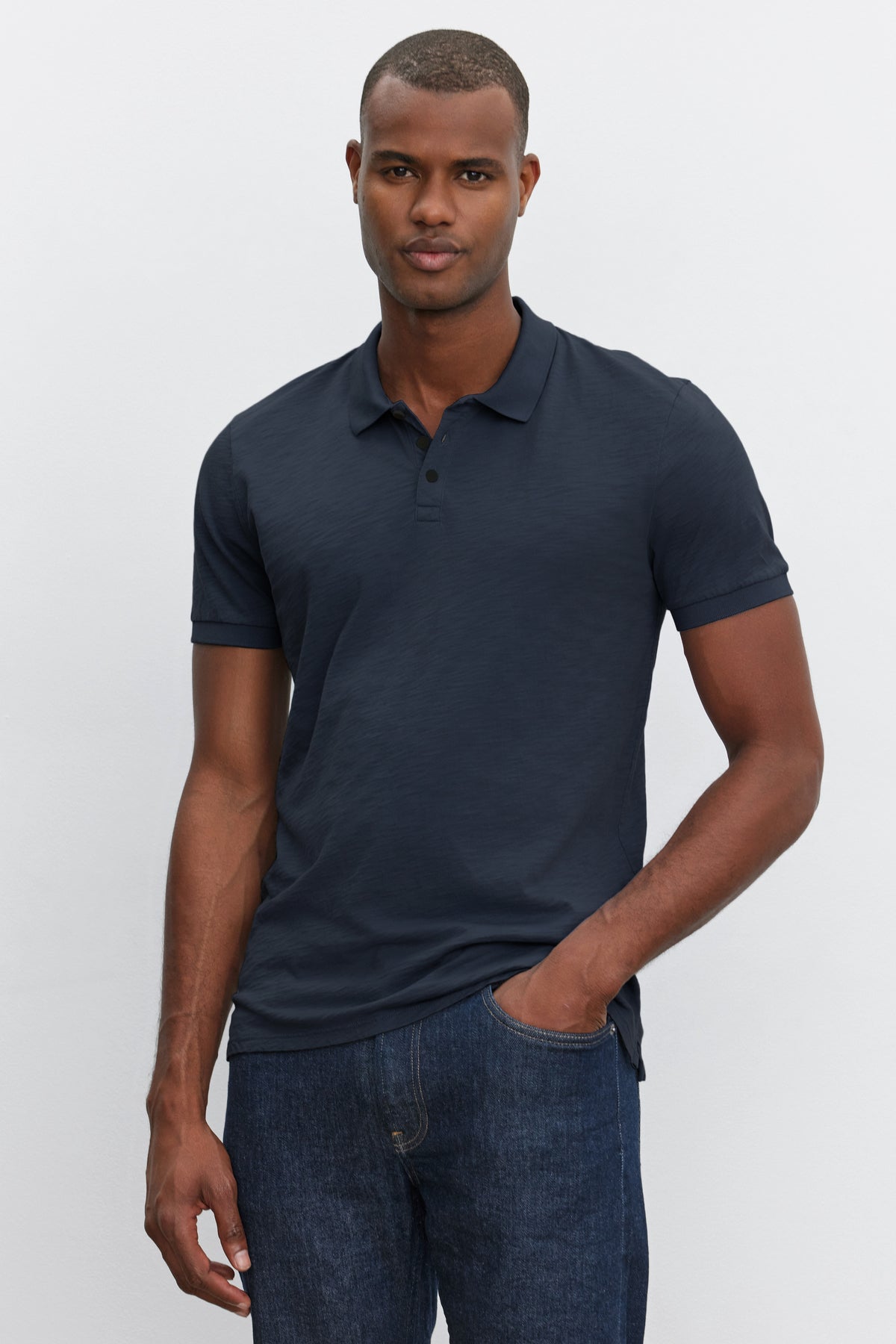 A man wearing a Dark Gray Cotton Slub NIKO POLO shirt from Velvet by Graham & Spencer stands against a plain white background, looking directly at the camera.-36890752745665