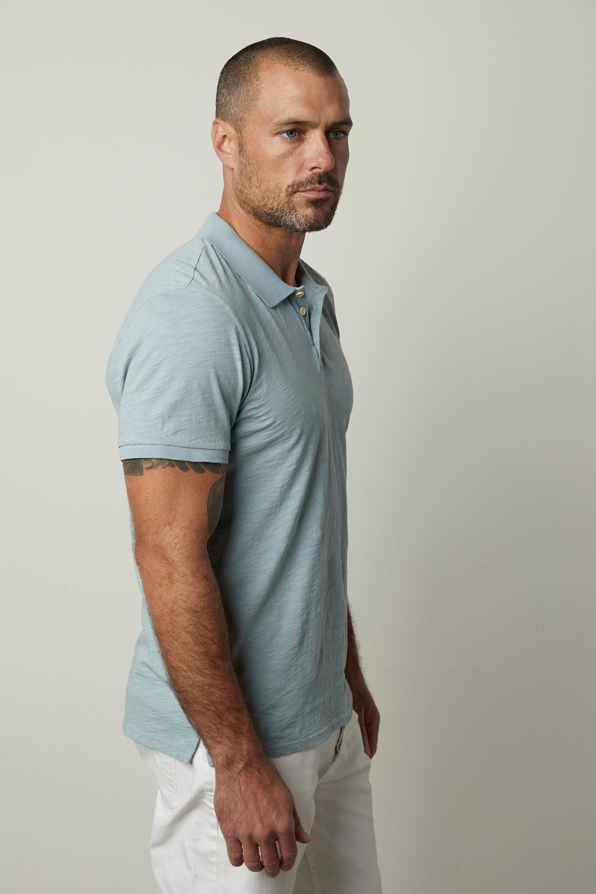 Niko Polo in Ojai Short Sleeve Collared Shirt with white pants close up side view of sleeve and collar-35783018021057