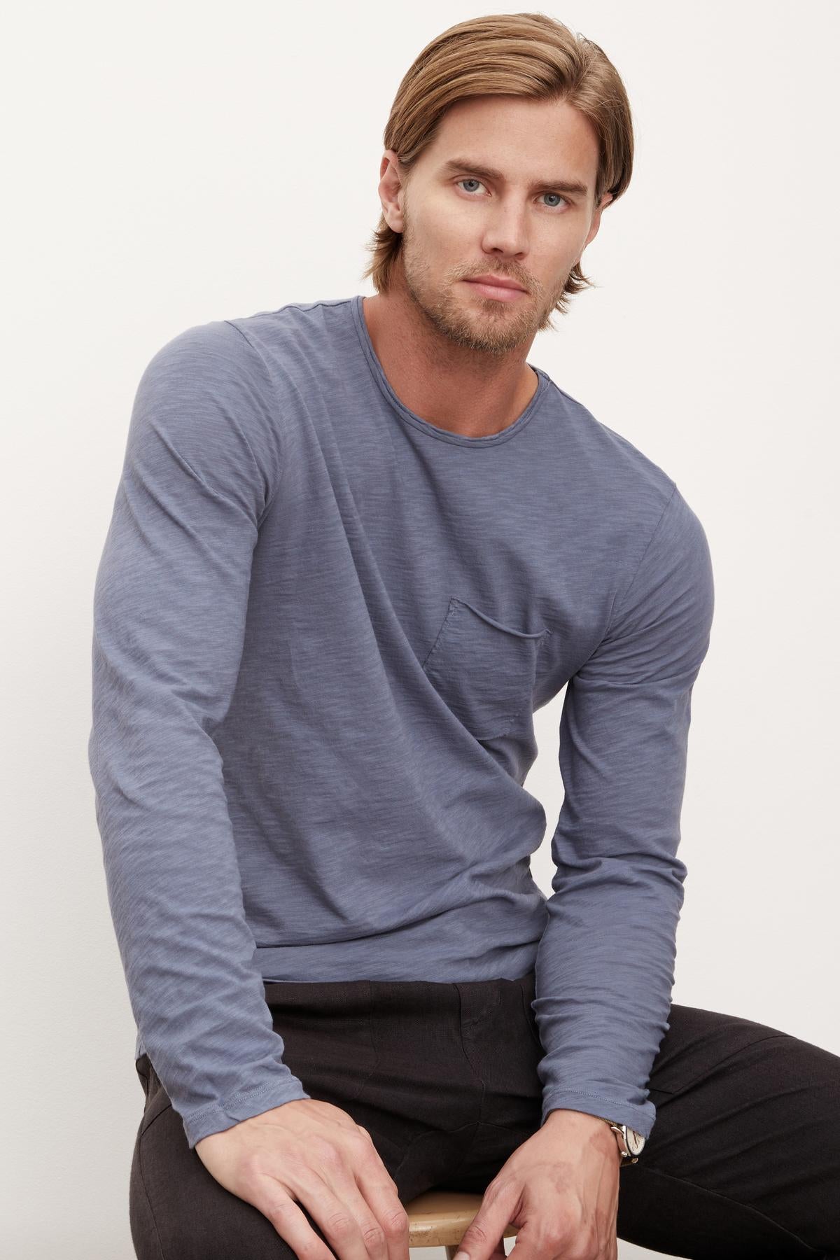 A man wearing a SIMEON RAW EDGE COTTON SLUB TEE by Velvet by Graham & Spencer, featuring raw-edge details and embodying California heritage.-36009054470337
