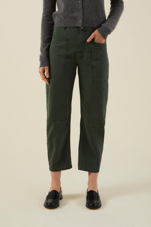 Velvet by Graham & Spencer BRYLIE PANT in dark green with a barrel leg and utilitarian patch pockets, worn with a grey cardigan and black loafers.