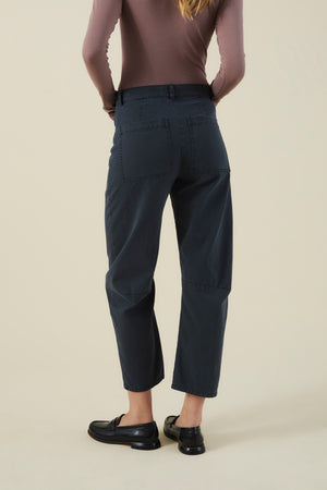 Back view of charcoal high-waisted barrel leg BRYLIE PANT with utilitarian patch pockets, paired with black loafers.