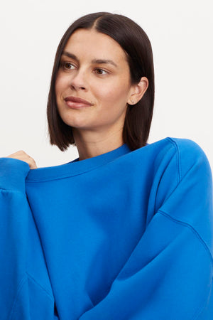 A model wearing the Velvet by Graham & Spencer Margot Oversized Sweatshirt in soft fleece.