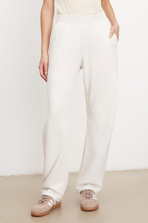 A woman wearing Velvet by Graham & Spencer's MATTY SOFT FLEECE SWEATPANT and a white tee.