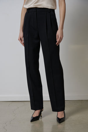 A woman wearing Velvet by Jenny Graham BUNDY PANT trousers and a blouse.